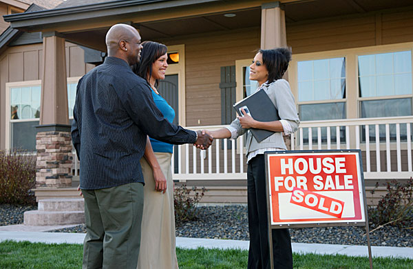 An Agent, selling real estate, along with a Home Stager Enter a home